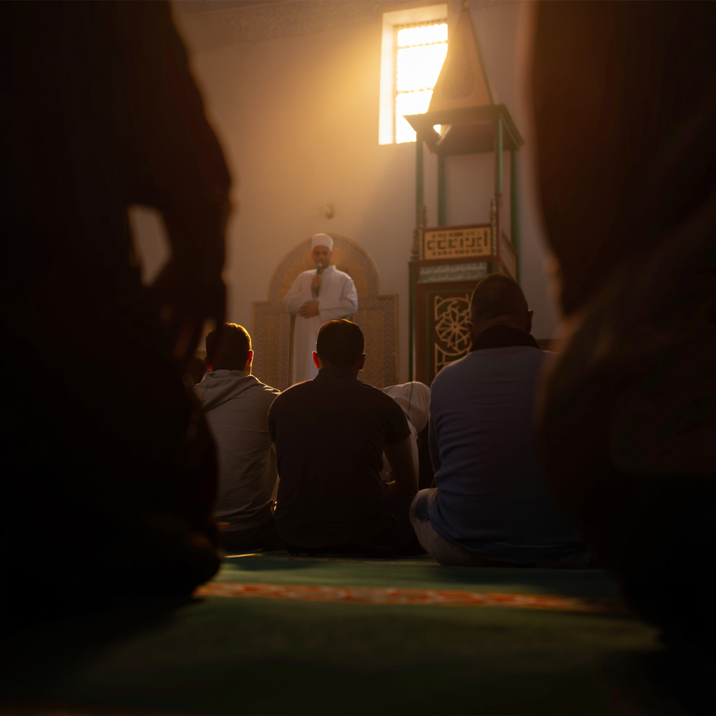 Imam delivering khutbah (back view)